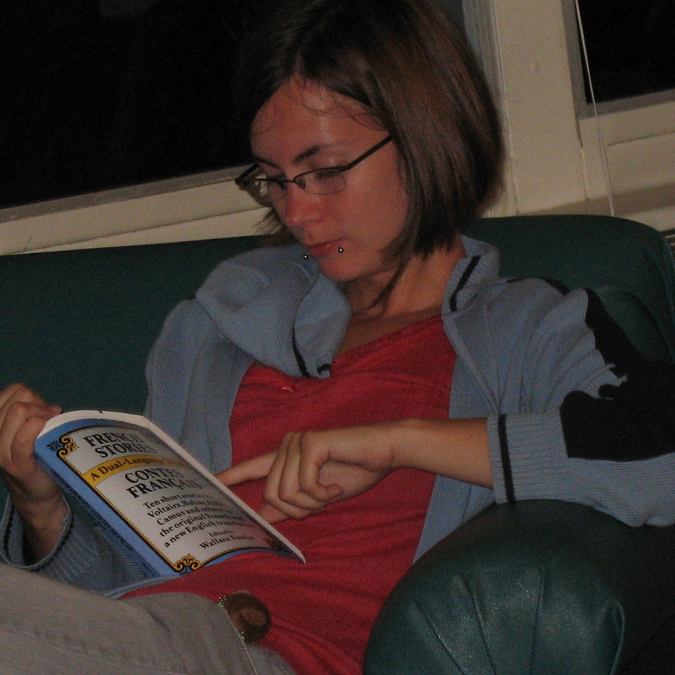A young woman reading a book.