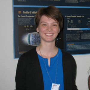 A young woman in front of a scientific poster.